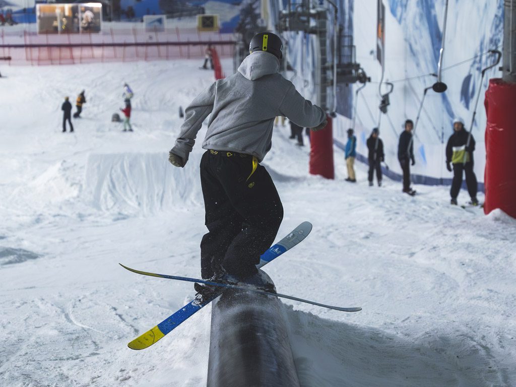 Skier on a rail feature at the park