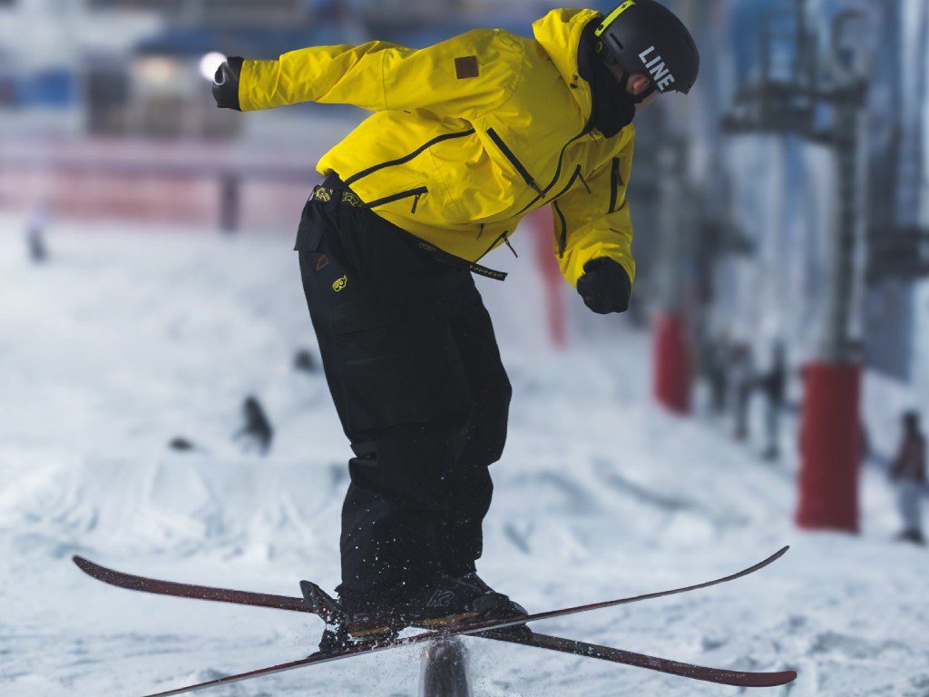Snowboarder riding over a medium jump