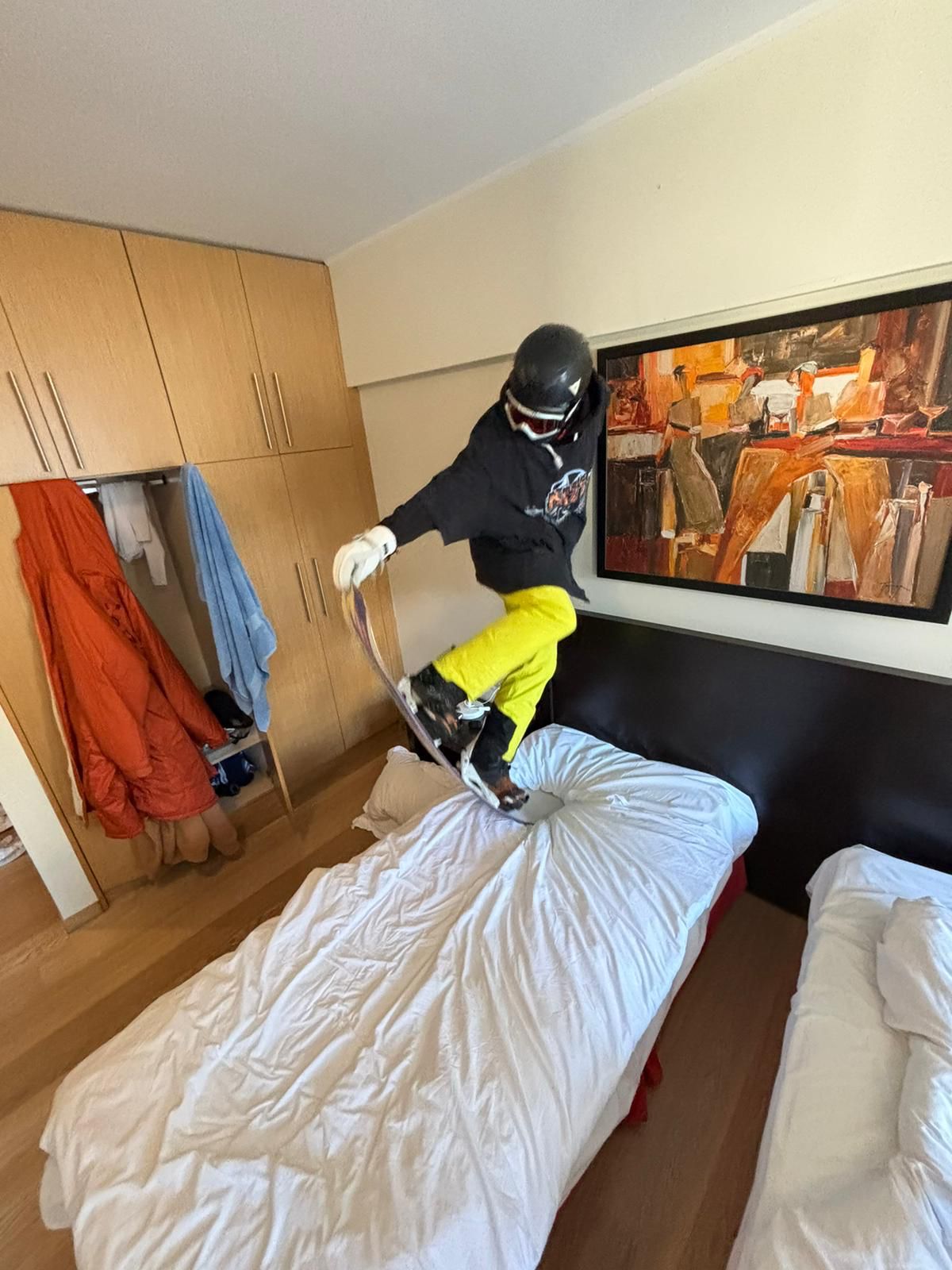 Snowboarder riding over a medium jump